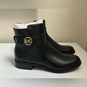 Black Micheal Kors Round-toe booties with inner ankle zipper closure. 1” heel